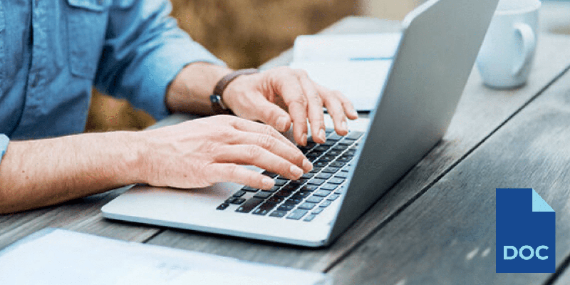 person's hands typing on a laptop keyboard