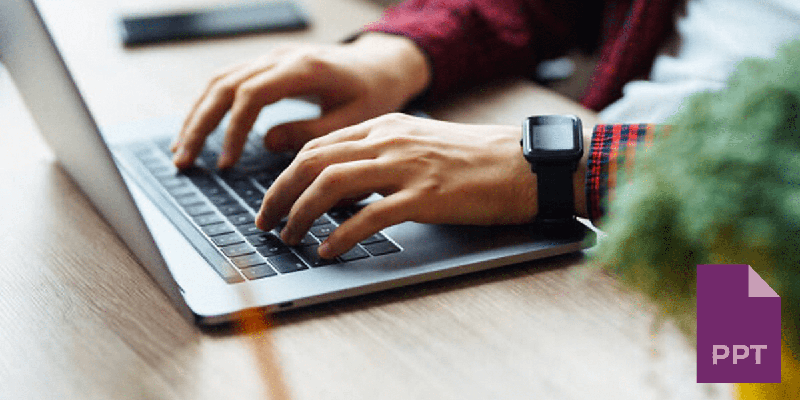 person's hands typing on a laptop keyboard